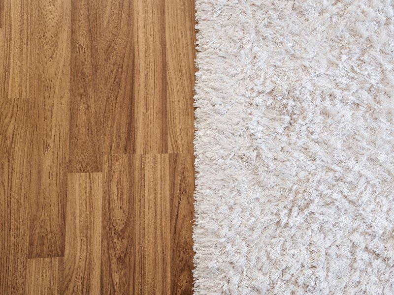 White rug on hardwood flooring - Carpet binding services from C G Interiors in San Leandro, CA
